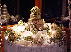 Wedding cake with peach and green flowers.
