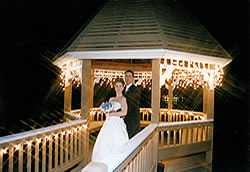 wedding couple in lit gazebo.