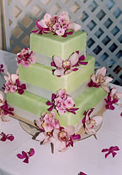 Green fondant wedding cake with pink orchids.