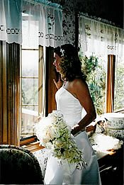 Bride looking out window.